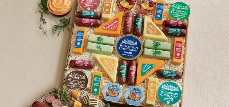 Shop Fall Harvest Photo of a gift-boxed assortment of numerous snack-sized cheeses, sausages, cheese spreads and mini tortes.