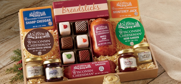 Shop Christmas Gifts Cardinal Tower: Assortment of cheeses, sausages, mixed nuts and sweets in cardinal/holiday-themed stacked boxes tied with a red ribbon